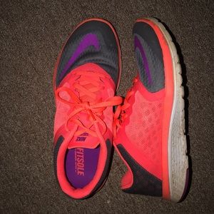 Orange, grey, and purple Nike running shoes